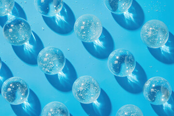 Beautiful and mesmerizing bubbles on a vibrant blue surface with water droplets glistening in the light