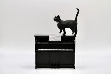 miniature figurine of a black cat with a piano