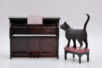 miniature figurine of a black cat with a piano