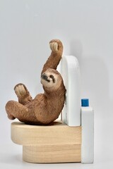 miniature figurine toy of a sloth on toilet - constipation concept