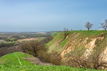 the steep bank of the Kuban River near the village of Dvubratsky on a sunny spring day