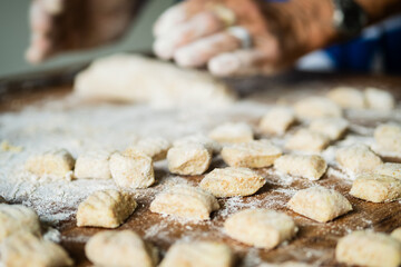 senior housewife making Italian pasta gnocchi traditional 