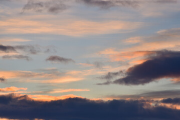 Evening sunset sky. Dark blue yellow clouds in the sky.