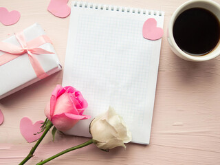Love composition - coffee cup, gift box and roses on pink background, top view. Valentines Day greeting card