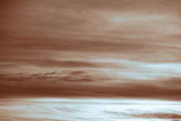 A dramatic sky, two layers like beach and ocean. colorful sky, before storm and during sunset. Huge clouds formations.