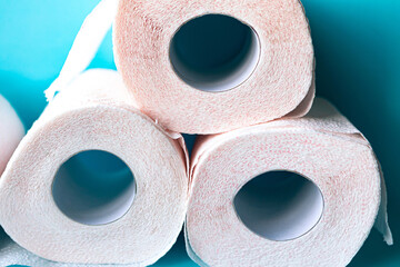 Soft, white toilet paper rolls on blue background