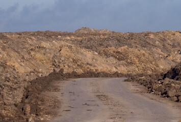 Red clay rocks filled in to line the road.
