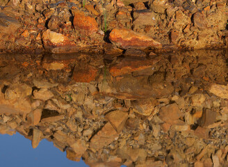 Red clay rocks filled in to line the road.