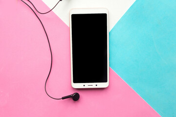 Mockup phone and headphones on geometric pink,white and blue paper background texture. Minimal concept.