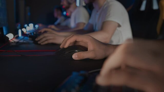 Professional E-sport tournament at computer club Cyber sport championship. Skill. Gaming mouse with RGB light on mat close up. Gamers team plays video game on PC. Multiplayer tactical shooter strategy