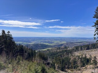 Overlooking green fields and winding roads from a high vantage point on a hill in the countryside