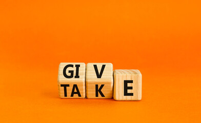 Give or take symbol. Concept word Give or Take on wooden cubes. Beautiful orange table orange...