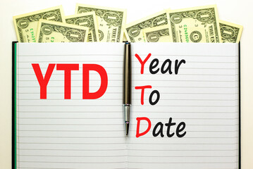 YTD year to date symbol. Concept words YTD year to date on beautiful white note. Dollar bills. Beautiful dollar bills background. Business YTD year to date concept. Copy space.