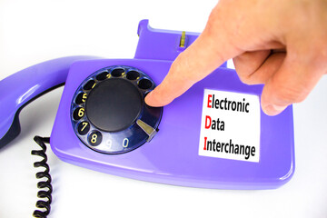 EDI electronic data interchange symbol. Concept words EDI electronic data interchange on old disk phone. Beautiful white background. Business and EDI electronic data interchange concept. Copy space.