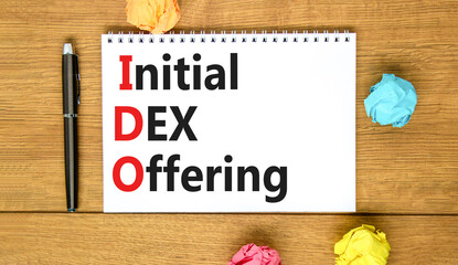 IDO initial DEX offering symbol. Concept words IDO initial DEX offering on beautiful white note. Beautiful wooden table wooden background. Business IDO initial DEX offering concept. Copy space.