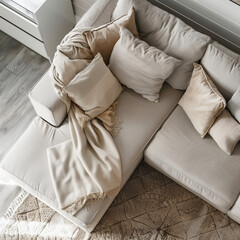 Beige corner sofa with pillows and blanket