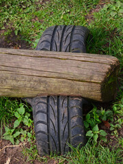 Wooden beam rocker with home-made dampers made from buried car tires