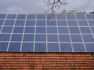 Solar photovoltaic system on the roof of an old farmhouse