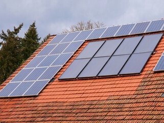 Solar photovoltaic system on the roof of an old farmhouse