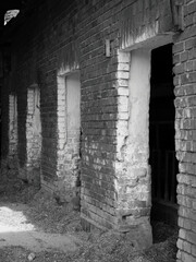 Fototapeta premium Old doors to a cow, horse or pigsty, black and white photograph