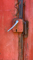 Close up photo of a weathered red old rusty door knob or handle with a vintage look - 778923702