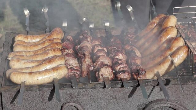 Meat is fried over hot coals in the grill. A barbecue will be cooked on the coals. Close-up.