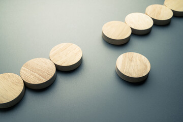 Concept image of a round wood blocks that move out from its position of a row, different, and original concept, create own way, or solution to solve the gap problem