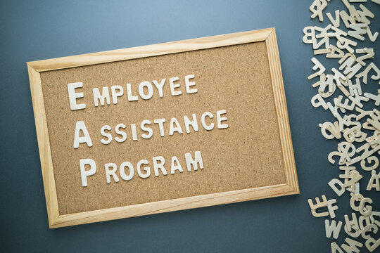Employee Assistance Program (EAP) by wooden letters arranged on the wood board