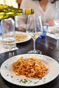 Tagliatelle al rag&ugrave; di cinghiale is a ty pica recipe from Italian Cuisine whit a glass of Verdicchio white wine