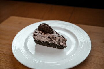 A slice of cookies and cream cheesecake on a plate
