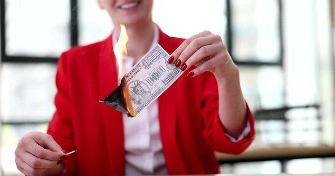 Businesswoman burning one million us dollar bill closeup 4k movie slow motion. Bankruptcy and inflation concept