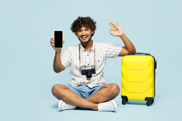 Full body traveler man wear white casual clothes sit near bag use blank screen mobile cell phone...