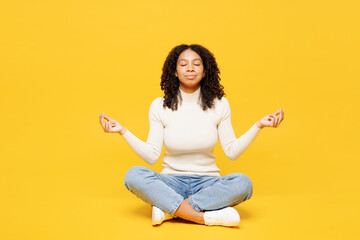 Full body little kid teen girl wear white casual clothes sits hold spreading hands in yoga om aum...
