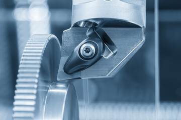 Close up  the  chip insert on the lathe machine in the light blue scene.