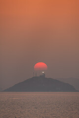 Sunset on an island with a lighthouse
