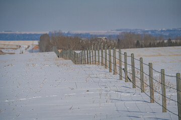 Farm Field Fence in Winter covered in snow