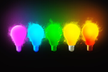 Creative bright colored light bulbs blow up with dry paint on a black background, concept. Creative idea and different thinking. Think. Electricity