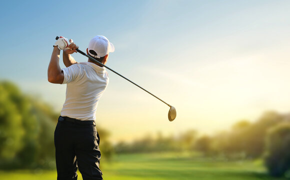 Golfer hit sweeping driver after hitting golf ball down the fairway with sunrise background.