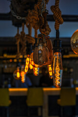Vintage light bulb with ropes and hangers in a rustic room in Paternoster, South Africa