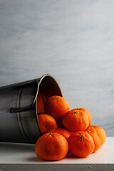 closeup of mandarin oranges in silver metal bucket - 778953385