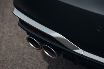 Sports car exhaust system pipes. Exhaust pipes in the middle of the bumper 