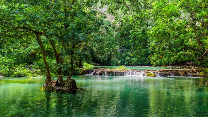 Natural background waterfall. Waterfall Emerald Pool, beautiful deep forest waterfall in ThailandNatural background waterfall. Waterfall Emerald Pool, beautiful deep forest waterfall in Thailand