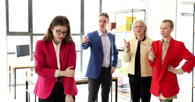 Employees in the office are ashamed of a colleague, a close-up. Psychological pressure at the workplace, mobbing