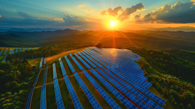 Aerial view of  photovoltaic power plant on the mountain at sunset