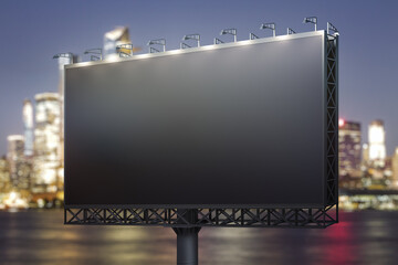 Blank black horizontal billboard on city buildings background at night, perspective view. Mockup, advertising concept