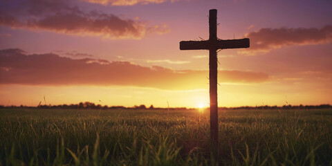 Silhouetted Cross at Sunset in Serene Field Landscape