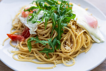 Italian spaghetti del poverello (Poor Man's Spaghetti), spaghetti pasta mixed with a lightly fried egg. Egg and cheese pasta, healthy food