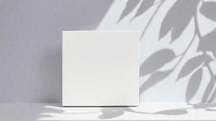 Soft shadows from leaves on a white wall. Square white mockup