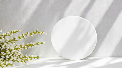 Monochrome wall with white round mockup and soft shadows from green branch