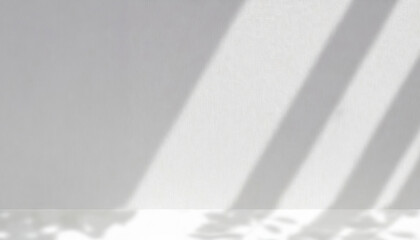 Soft and geometric shadows on a white wall. Part of the wall is light, part is in shadow